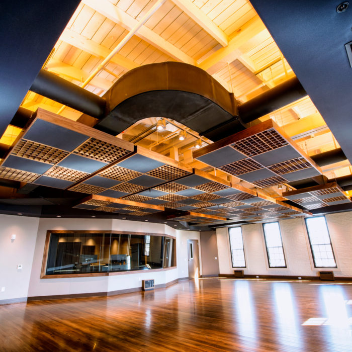 Studio space with exposed structural components and modern lighting at 210 York Street